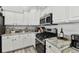 Bright kitchen with white cabinets and granite countertops at 609 Salt Lake Dr, Tarpon Springs, FL 34689