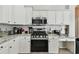 Well-equipped kitchen, featuring stainless steel appliances and white cabinets at 609 Salt Lake Dr, Tarpon Springs, FL 34689