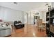 Spacious living room with hardwood floors, neutral decor, and access to dining area at 609 Salt Lake Dr, Tarpon Springs, FL 34689