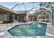 Inviting pool area with screened enclosure, perfect for relaxation and entertainment at 609 Salt Lake Dr, Tarpon Springs, FL 34689