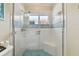 Bright bathroom with a large walk-in shower and tiled walls at 609 Salt Lake Dr, Tarpon Springs, FL 34689
