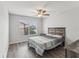 Bright bedroom with wood-look floors and large window at 6428 Gloria Dr # 26, New Port Richey, FL 34653