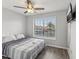 Bedroom with large window, ceiling fan, and TV at 6428 Gloria Dr # 26, New Port Richey, FL 34653