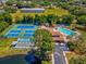 Aerial view showing tennis courts and community pool at 6428 Gloria Dr # 26, New Port Richey, FL 34653