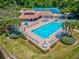 Aerial view of community pool, lounge chairs, and tennis courts at 6428 Gloria Dr # 26, New Port Richey, FL 34653
