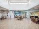 Community room with seating areas, pool view, and tiled floors at 6428 Gloria Dr # 26, New Port Richey, FL 34653