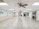 Large community room with tiled floor and ceiling fan at 6428 Gloria Dr # 26, New Port Richey, FL 34653