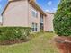 Condo building exterior showcasing landscaping and a manicured lawn at 6428 Gloria Dr # 26, New Port Richey, FL 34653