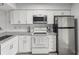 Modern kitchen with stainless steel appliances and white cabinets at 6428 Gloria Dr # 26, New Port Richey, FL 34653
