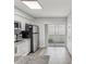 Modern kitchen with stainless steel appliances and access to a balcony at 6428 Gloria Dr # 26, New Port Richey, FL 34653