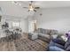 Open living and dining area with gray sectional sofa and wood-look floors at 6428 Gloria Dr # 26, New Port Richey, FL 34653