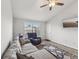 Living room with gray sectional sofa, recliner, and wood-look floors at 6428 Gloria Dr # 26, New Port Richey, FL 34653