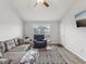 Living room with gray sectional sofa, recliner, and wood-look floors at 6428 Gloria Dr # 26, New Port Richey, FL 34653