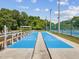 Two shuffleboard courts with benches and surrounding greenery at 6428 Gloria Dr # 26, New Port Richey, FL 34653