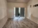 Bright living room featuring wood-look floors and sliding glass doors at 8124 Golf Club Ct, Hudson, FL 34667