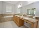 Primary bathroom with double vanity and soaking tub at 8424 Bluevine Sky Dr, Land O Lakes, FL 34637