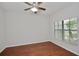 Spacious bedroom with wood flooring and a large window at 8424 Bluevine Sky Dr, Land O Lakes, FL 34637