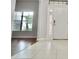 Bright entryway with tile floors and a view into the living room at 8424 Bluevine Sky Dr, Land O Lakes, FL 34637