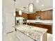 Modern kitchen with stainless steel appliances and granite countertops at 8424 Bluevine Sky Dr, Land O Lakes, FL 34637