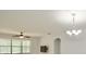 Living room with ceiling fan and chandelier at 8424 Bluevine Sky Dr, Land O Lakes, FL 34637