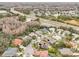 Aerial view showcasing a community of houses with pools and green spaces at 8831 Bel Meadow Way, Trinity, FL 34655