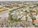 Aerial view of a residential neighborhood with houses, pools, and lush landscaping at 8831 Bel Meadow Way, Trinity, FL 34655