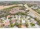 Aerial view showing a neighborhood of homes near a highway and conservation area at 8831 Bel Meadow Way, Trinity, FL 34655