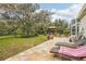 Relaxing backyard patio with lounge chairs,gazebo, and lush landscaping at 8831 Bel Meadow Way, Trinity, FL 34655
