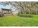 Spacious backyard with large oak tree and grassy area at 8831 Bel Meadow Way, Trinity, FL 34655