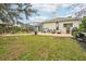 Spacious backyard oasis with a screened-in pool, patio, and outdoor kitchen at 8831 Bel Meadow Way, Trinity, FL 34655