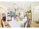 Elegant dining room with chandelier and seating for six at 8831 Bel Meadow Way, Trinity, FL 34655