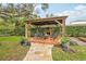 Brick patio gazebo with fireplace and seating area at 8831 Bel Meadow Way, Trinity, FL 34655