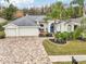 Two-car garage, large driveway, and lush landscaping at 8831 Bel Meadow Way, Trinity, FL 34655