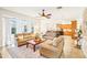 Open concept living room with views into kitchen and access to backyard at 8831 Bel Meadow Way, Trinity, FL 34655
