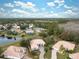 Aerial view of home and neighborhood, showcasing a lake nearby at 9090 Alexandria Dr, Weeki Wachee, FL 34613