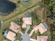 Aerial view of houses, showing a cul-de-sac and pool at 9090 Alexandria Dr, Weeki Wachee, FL 34613