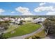 Aerial view of community with clubhouse, pool, and tennis courts at 9090 Alexandria Dr, Weeki Wachee, FL 34613