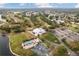 Aerial view of community with golf course, pool, and clubhouse at 9090 Alexandria Dr, Weeki Wachee, FL 34613