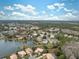 Aerial view of homes and community features, including a lake at 9090 Alexandria Dr, Weeki Wachee, FL 34613
