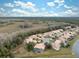 Aerial view of neighborhood with lake and lush landscaping at 9090 Alexandria Dr, Weeki Wachee, FL 34613