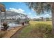 Landscaped backyard with pool and golf course view at 9090 Alexandria Dr, Weeki Wachee, FL 34613