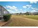 Landscaped backyard with a view of the golf course at 9090 Alexandria Dr, Weeki Wachee, FL 34613
