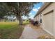Backyard with a patio, landscaping, and partial view of garage at 9090 Alexandria Dr, Weeki Wachee, FL 34613
