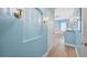 Bathroom hallway with light blue walls and wood floors at 9090 Alexandria Dr, Weeki Wachee, FL 34613