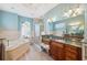 Elegant bathroom with soaking tub, double vanity, and walk-in shower at 9090 Alexandria Dr, Weeki Wachee, FL 34613