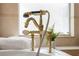 Close-up of a gold bathtub faucet with ornate details at 9090 Alexandria Dr, Weeki Wachee, FL 34613