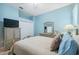 Light blue bedroom with a queen bed, dresser, and built-in closet at 9090 Alexandria Dr, Weeki Wachee, FL 34613