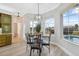 Breakfast nook with glass table, four chairs and pool view at 9090 Alexandria Dr, Weeki Wachee, FL 34613