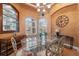 Bright dining room with glass top table and display cabinet at 9090 Alexandria Dr, Weeki Wachee, FL 34613