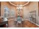Elegant dining room with glass table and decorative clock at 9090 Alexandria Dr, Weeki Wachee, FL 34613